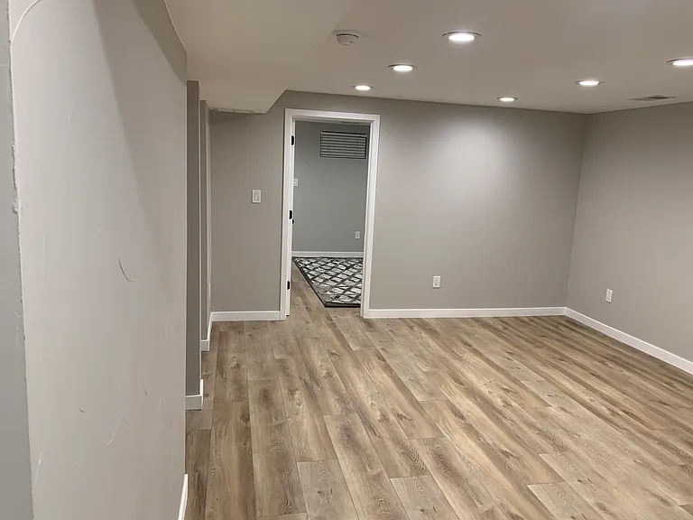 View of bedroom door from living room in basement
