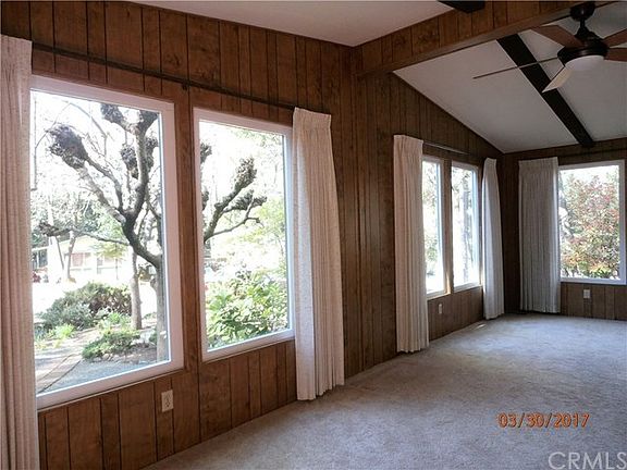 Large living room with vaulted ceilings and large windows with a great view to the garden.