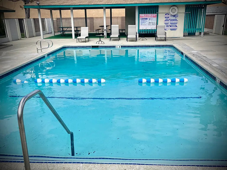 Sparkling Resident community pool with shaded picnic area