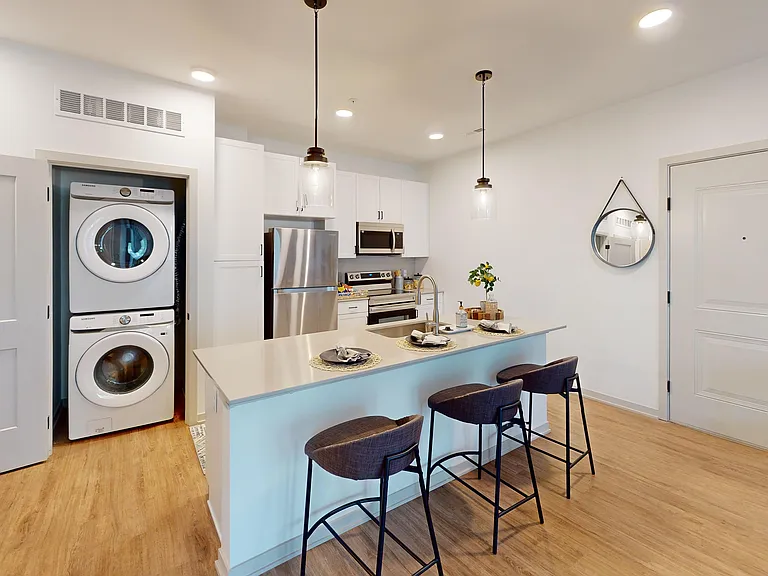 Furnished open-concept kitchen in The Henry floor plan at Nese.