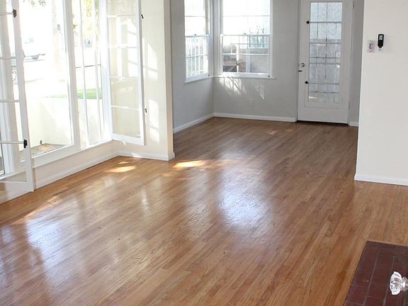 Living room view to dining area, many windows with lots of light