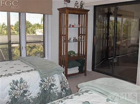 Guest bedroom upstairs with canal view and sliders to balcony