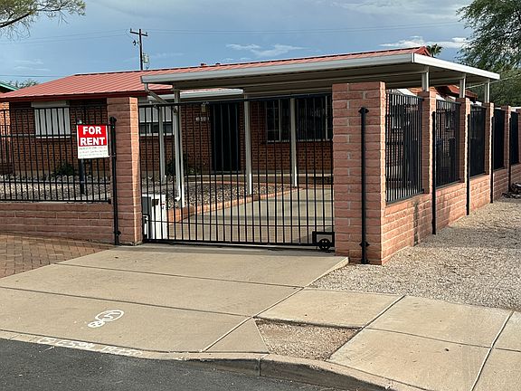 House front showing gated carport