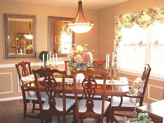 Formal dining room, chair rail & chandelier.