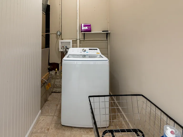 Washing machine in the Laundry room with Cart to move to dryer.