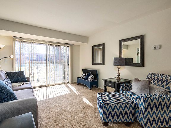 Spacious living room with natural light at Three Oaks Apartments in Troy, MI