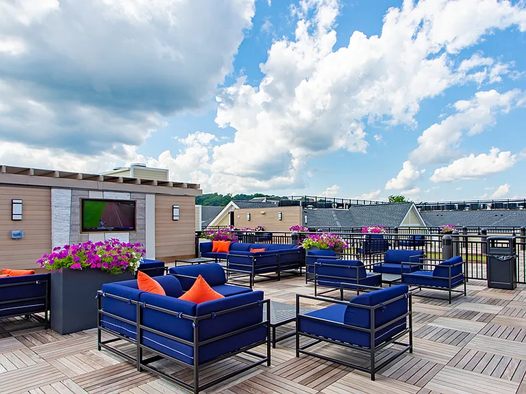 Expansive open rooftop area with outdoor television and sitting space