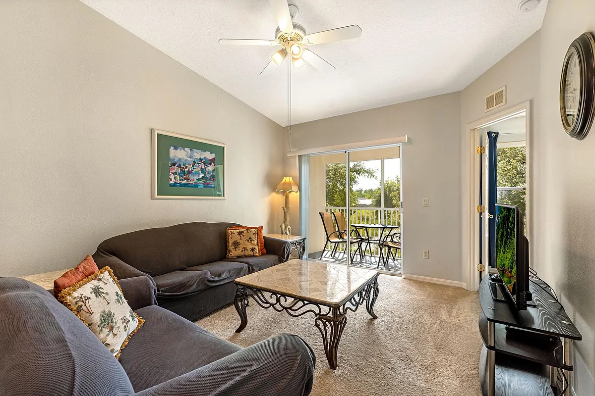 Living Area with Lake View - 8825 Grand Palms Cir