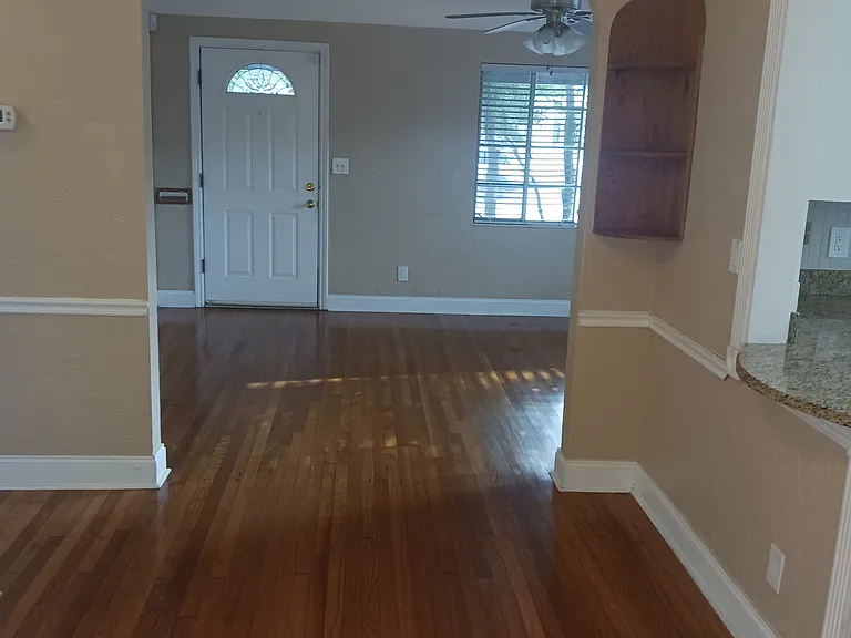 View from dining area toward front entry and living room.