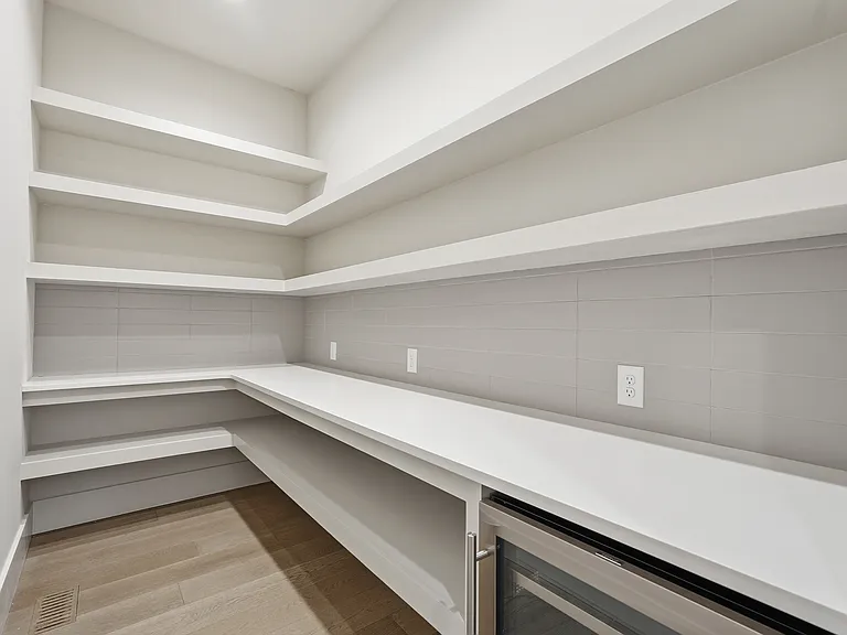 Walk in pantry with built in shelving for storage