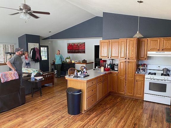 Kitchen. Wood flooring looking towards front door and stairwell