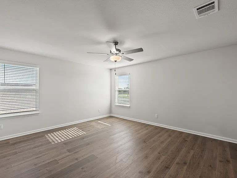 The master bedroom has two large windows that let in great, natural light.