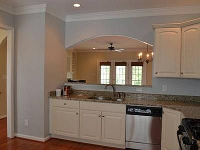 Main floor Bright kitchen overlooking family room. 2 dedicated parking spaces adjacent to front entrance of home.