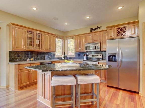 Gorgeous kitchen with granite on island and backsplash. SS appliances.