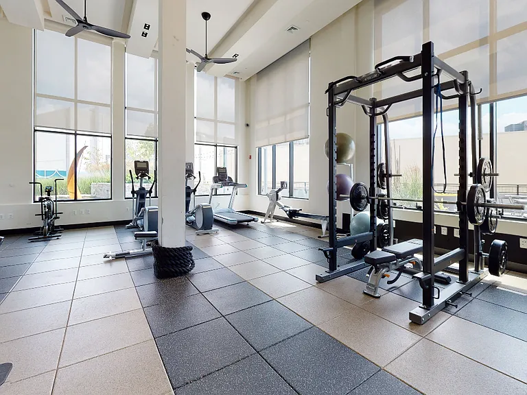 Floor to ceiling windows flood this fitness center with natural light