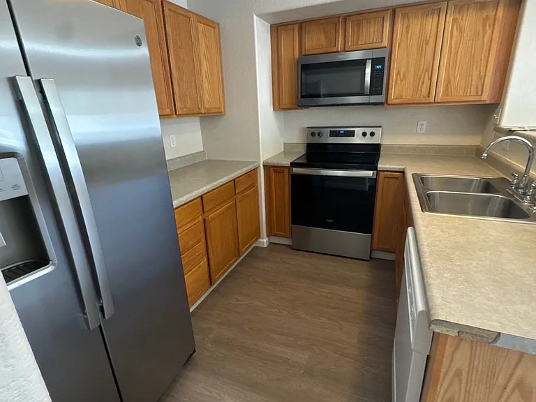 Kitchen with new stainless steel appliances.