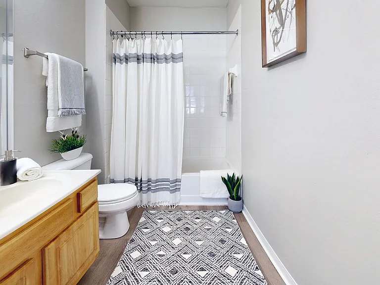 Featuring large mirrors and a tiled shower/tub combo, your bathroom is the perfect place to pamper yourself.