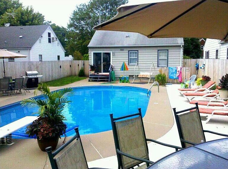 Backyard w/  in-ground pool.
