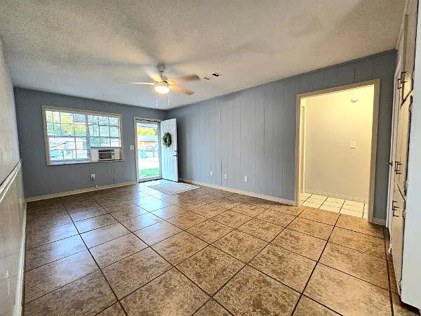 On the side of the family room / living room area is the entrance to the hall that leads to the two bedrooms and the bathroom