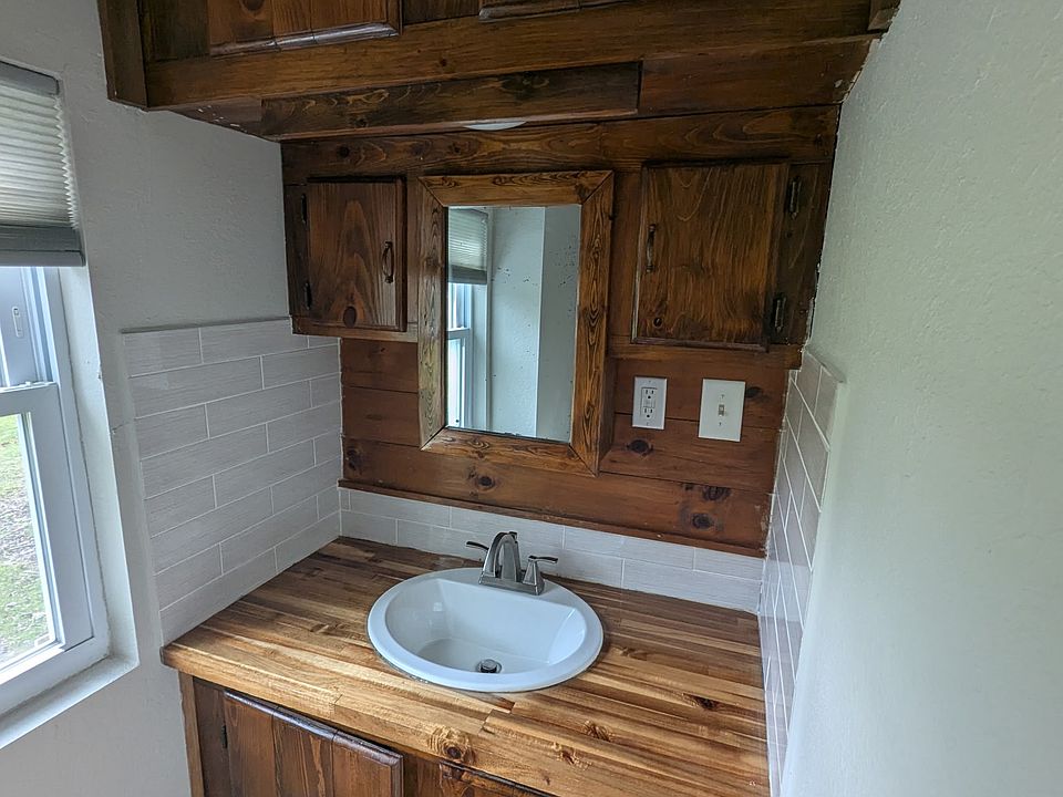 Refinished pine cabinetry with modern countertop.