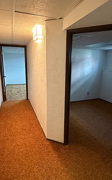 Downstairs hallway showing both rooms, without virtually staging