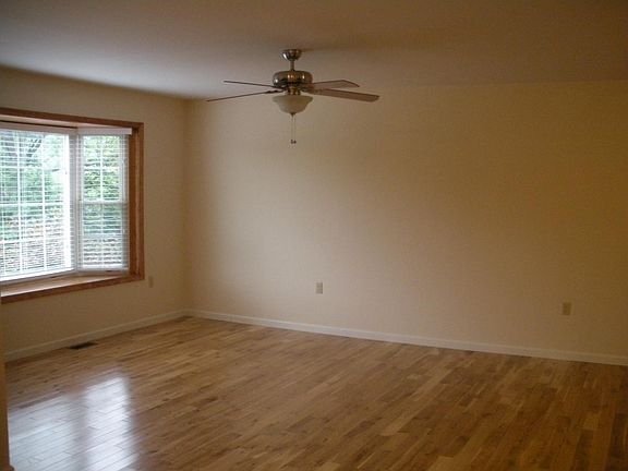 Living Room with fan and bay window