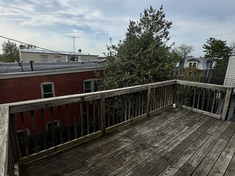 spacious deck overlooking the yard with a fire escape staircase