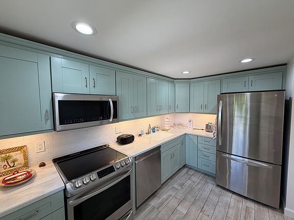 Martha Stewart designer cabinets, new appliances and hot-water tap for hot beverages.