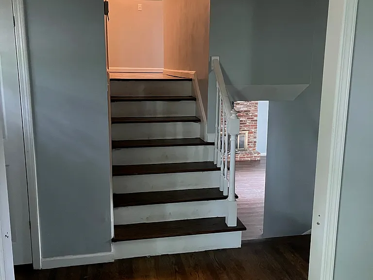 Stairs heading to bedrooms and to lower living room