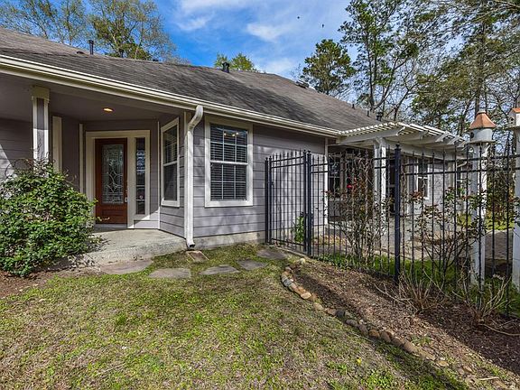 Oversized covered front porch so your guests and delivery items do not get wet. Beautiful iron gate to the side yard with pergola and patio area