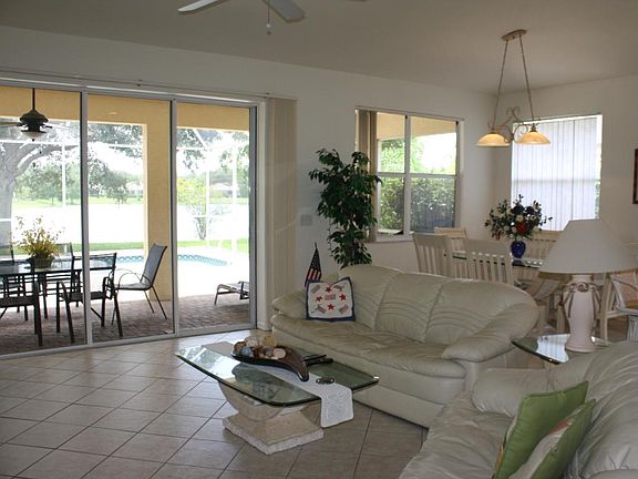 Living Room, Dining Room, Lanai and pool overlooking the lake