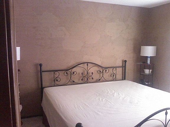 The wallpaper in the master bedroom is multi toned.