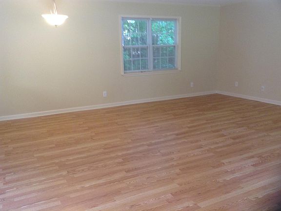 Similar pic of living room showing windows that view the woods in the back of the house.