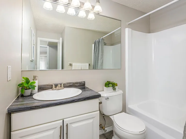 Elevate your daily routine in your bathroom retreat, featuring an oversized mirror that adds space, light, and a touch of luxury to your every day.