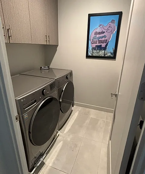 Laundry room with sink located on second floor between the primary and second bedroom.