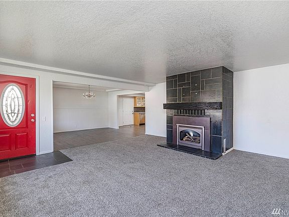 Gorgeous Tiled Gas Fireplace in the Living Room is Open to Dining room.