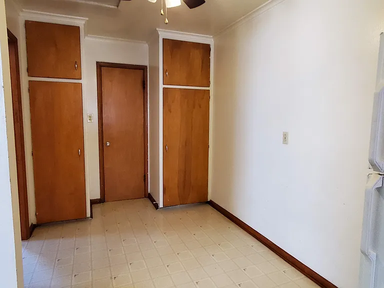 Pantry and storage cabinets in the dining or office area.