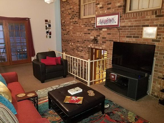 Den with HGTV brick wall