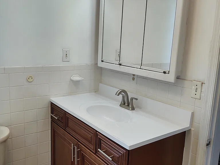 Brand new sink and vanity in full bathroom.