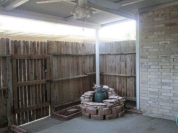 COVERED PATIO has a Water Feature and the Patio has Indoor/ Outdoor Carpet and Ceiling Fan.