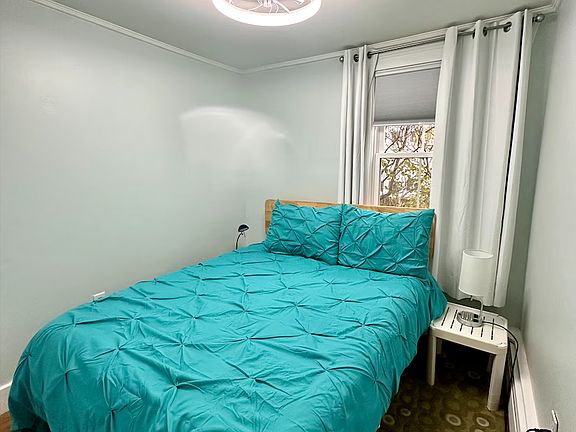 The second bedroom features a full bed and charging ports