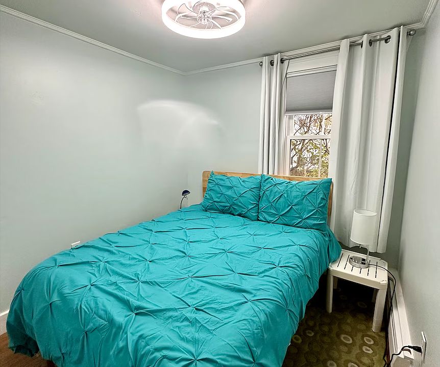 The second bedroom features a full bed and charging ports