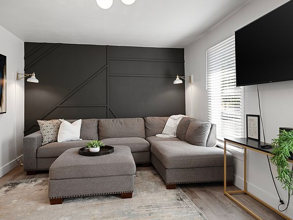 Living room with sectional and 60 inch tv