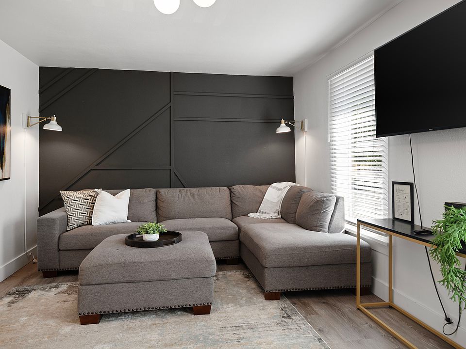 Living room with sectional and 60 inch tv