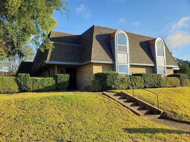 Front view of home set up above the street level.
