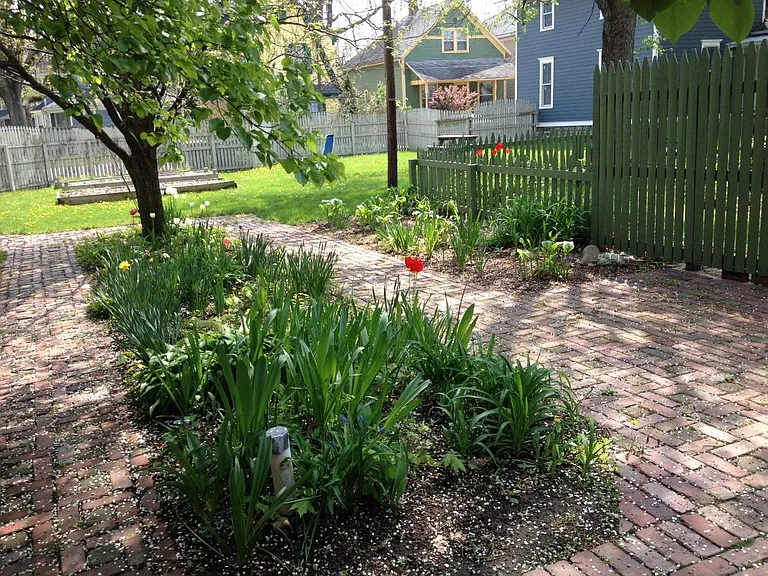 Rose Place Properties courtyard, common space and organic community garden plots.
