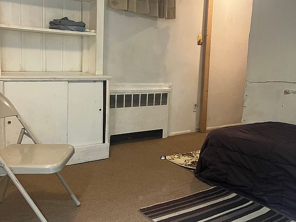 BDRM w twin bed, radiator, exit to kitchenette