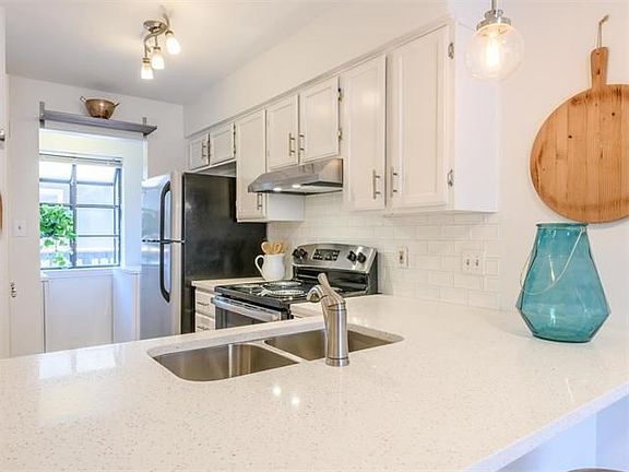 Tons of natural light and a picture box window ready for your own herb garden. Full size washer and dryer also convey.