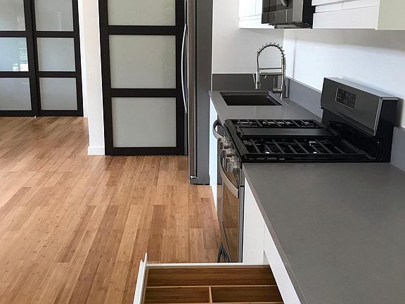 ASIAN STYLE BARN DOOR AND CLOSET, BAMBOO FLOORING AND DRAWERS WITH CAESARSTONE COUNTERTOPS