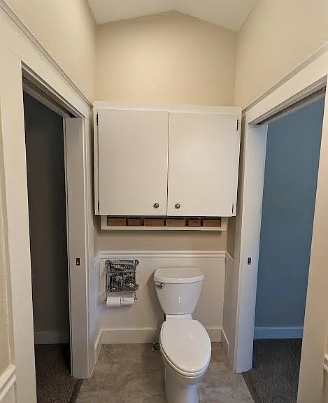 Upstairs bathroom with storage over toilet.